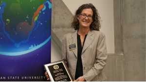 Dr. Rachel Shinnar holds a plaque during App State's Global Leadership Awards Ceremony