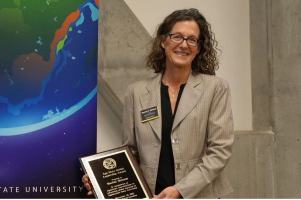 Dr. Rachel Shinnar holds a plaque during App State's Global Leadership Awards Ceremony